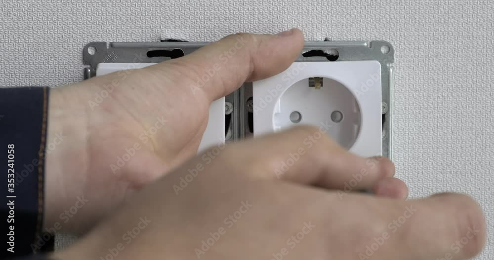 Electrician removes installed sockets and switches, twogang switch and