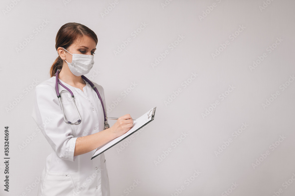 Young female professional doctor is holding something in an empty hand, isolated on a light background Young female professional doctor is holding something in an empty hand, isolated on a light background