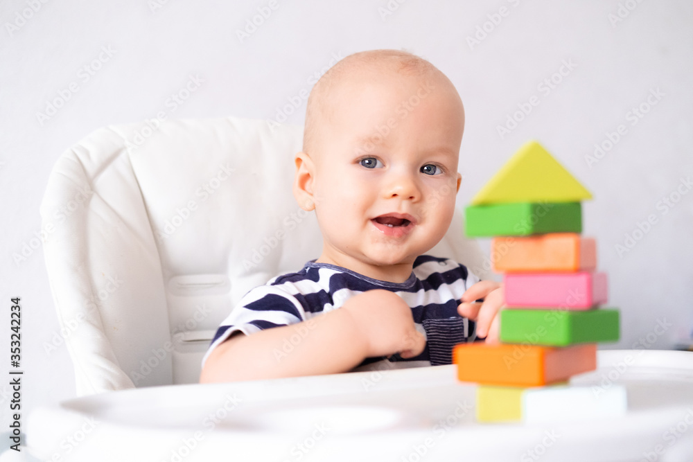 baby game. Little clever caucasian child playing colorful wood toys sitting on highchair. games for early development. New born infant kids leisure. baby game. Little clever caucasian child playing colorful wood toys sitting on highchair. games for early development. New born infant kids leisure.