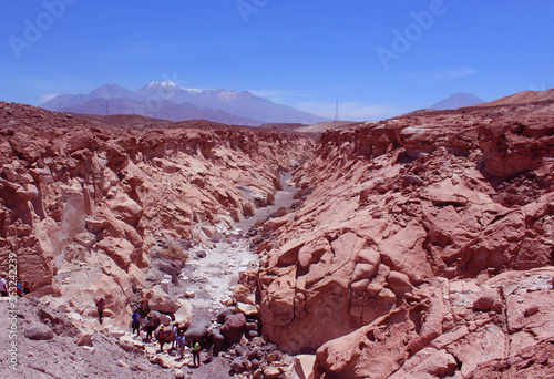 Tourists exploring a small canyon