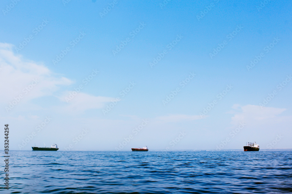 Seascape with three cargo ships
