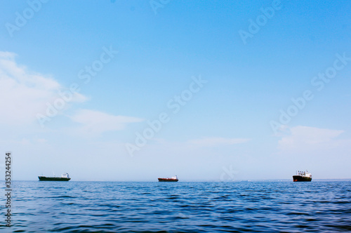 Seascape with three cargo ships