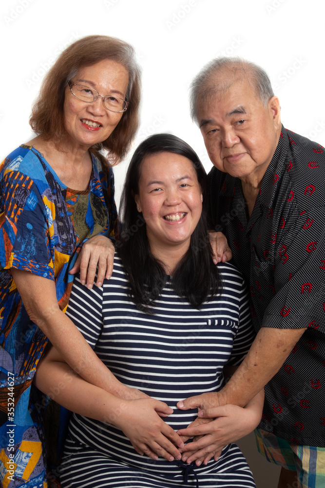 Portraiture Happy Asia Malaysian Chinese elder couple with them pregnant daughter on white background. Portraiture Happy Asia Malaysian Chinese elder couple with them pregnant daughter on white background.