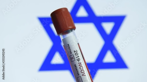 Corona virus or Covid-19 in Israel , sample blood tube with Israel flag on background