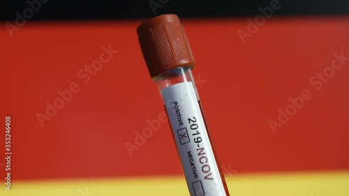 Corona virus or Covid-19 in Germany , sample blood tube with Germany flag on background