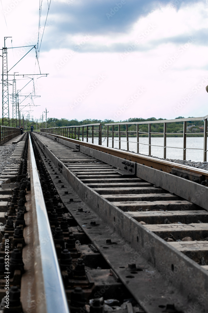 railway tracks along the bridge crossing the river