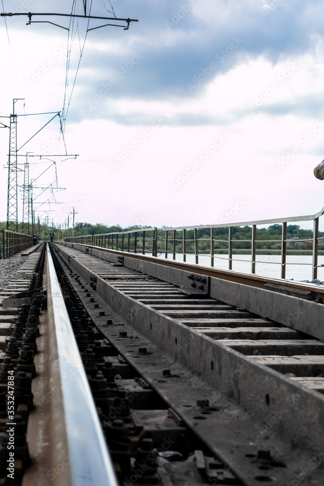 railway tracks along the bridge crossing the river