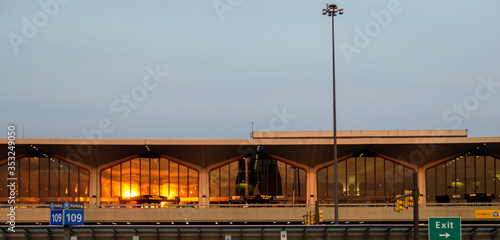 sunset orange light reflecting on windows of terminal building in Newark Airport