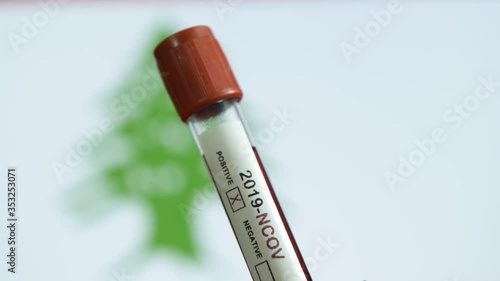 Corona virus or Covid-19 in Lebanon , sample blood tube with Lebanon flag on background
