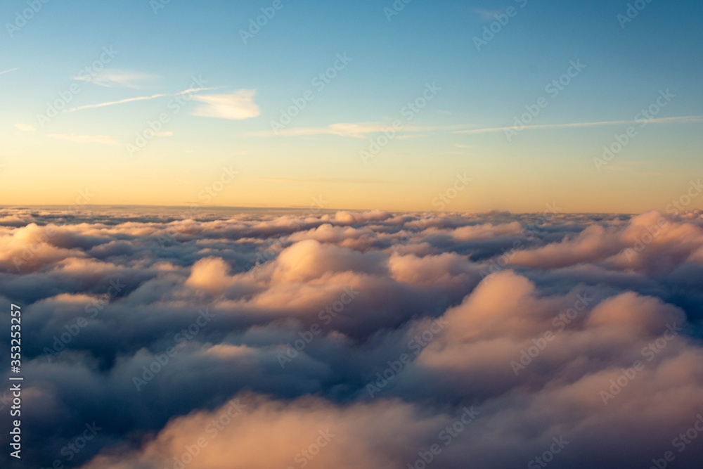 Sunset colors over the clouds in areal view