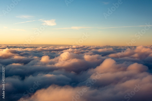 Sunset colors over the clouds in areal view