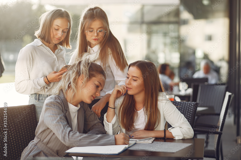 Students in a park. Girls on a campus. Friends sitting at the table. Students in a park. Girls on a campus. Friends sitting at the table.