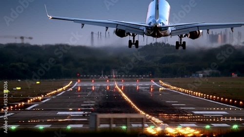 Airplane is landing at HAM Airport at dawn
