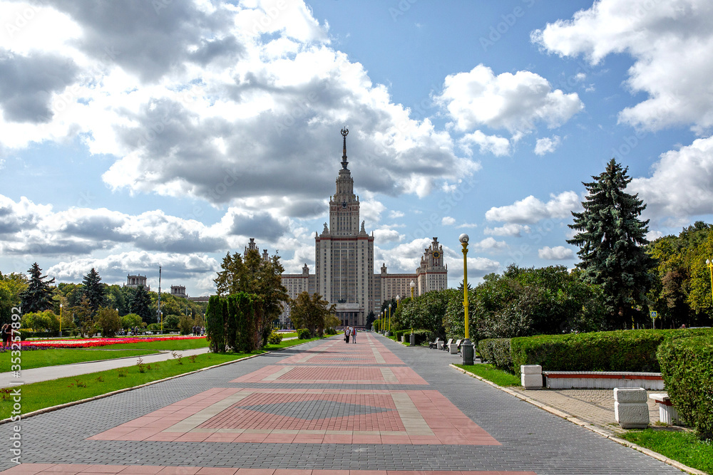 Obraz premium The building of the main higher educational institution in Moscow. Park with tree-lined avenues.