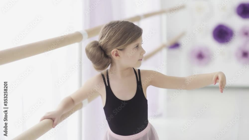 Close up of Little Ballerina In Pointe Practicing Dance At Classical Ballet School Close up of Little Ballerina In Pointe Practicing Dance At Classical Ballet School