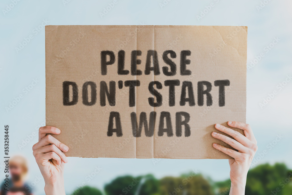 The phrase " Please don't start a war " on a banner in men's hand ...