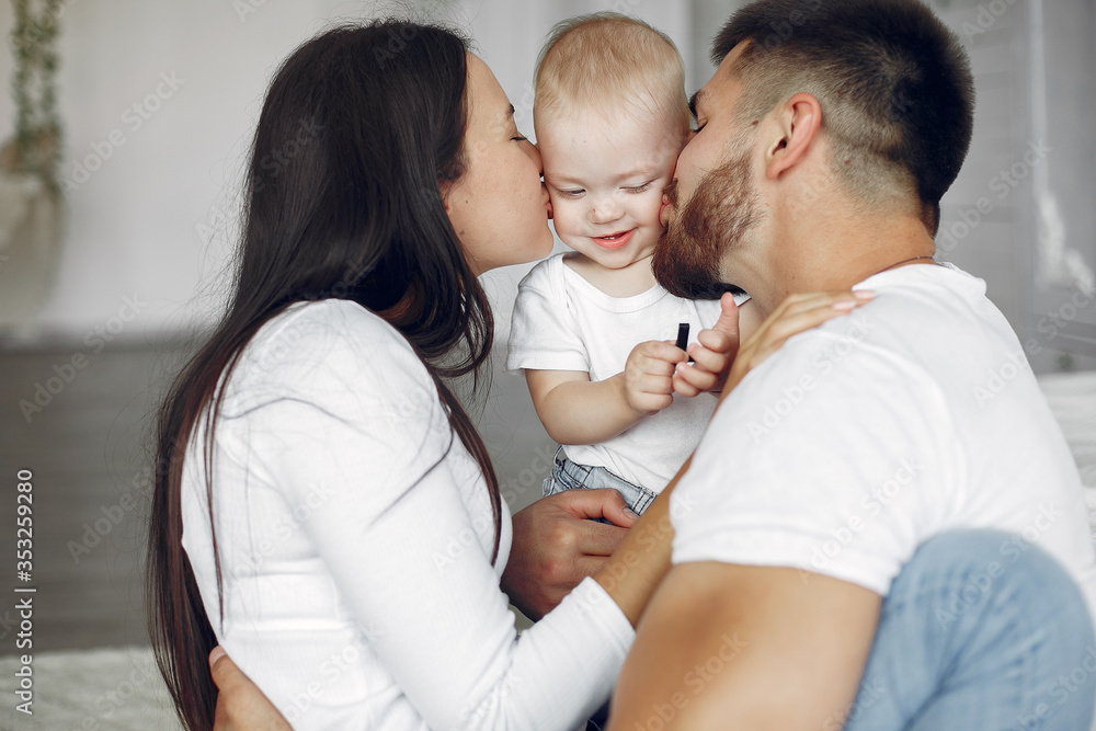 Cute family in a room. Lady in a white shirt. Little boy with parents Cute family in a room. Lady in a white shirt. Little boy with parents