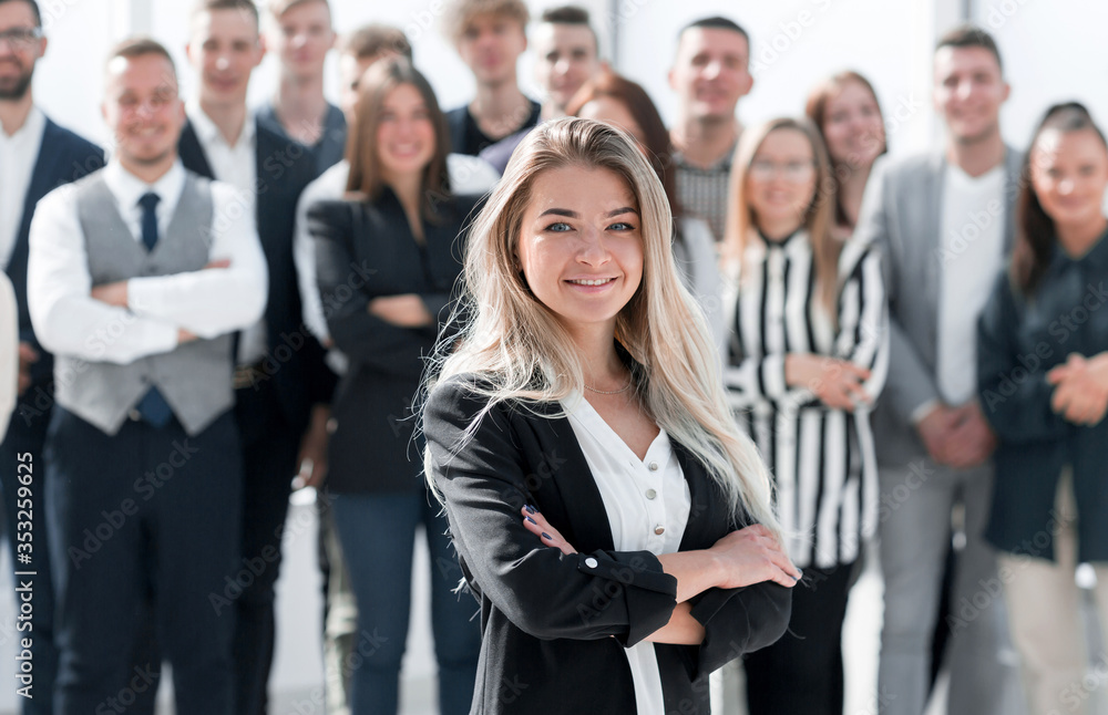 ambitious young business woman standing in front of her colleagues ambitious young business woman standing in front of her colleagues