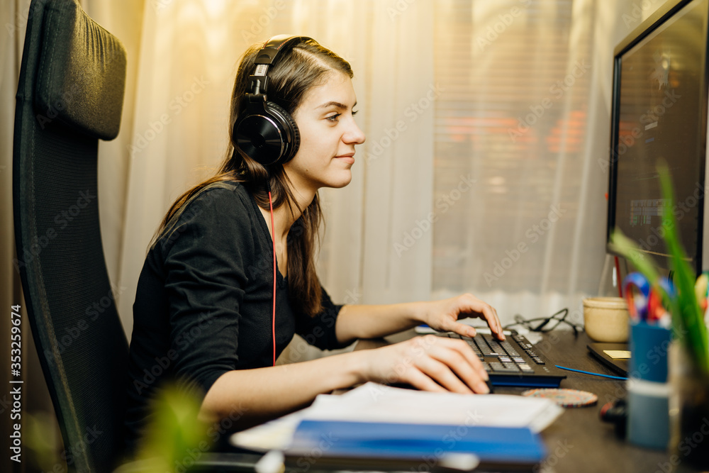 Woman working from home on a desktop computer.Online business career.Freelance remote worker.Productivity and motivation.Video editor.Home schooling online class.All nighter.Searching for job online Woman working from home on a desktop computer.Online business career.Freelance remote worker.Productivity and motivation.Video editor.Home schooling online class.All nighter.Searching for job online