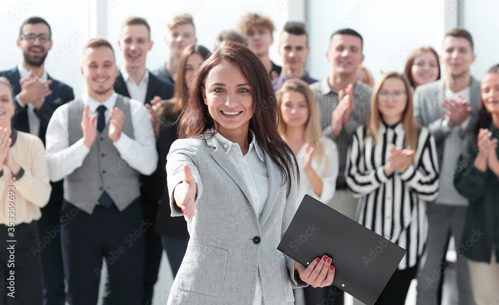 friendly business woman holding out her hand for a handshake friendly business woman holding out her hand for a handshake