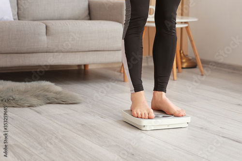 Young woman measuring her w...