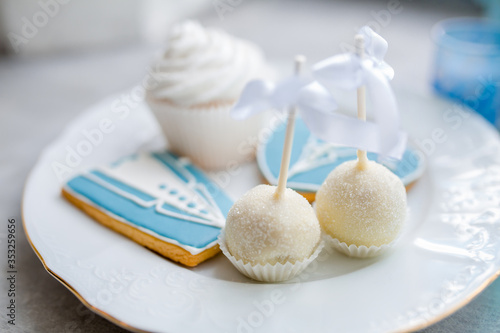 White cupcakes with sugar. Morning of the bride. Sweets and cakes are in candy bar for the wedding ceremony. Selective focus.