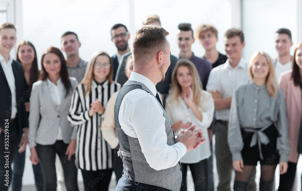 young leader looking at a happy business team. young leader looking at a happy business team.