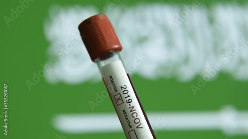 Corona virus or Covid-19 in Saudi Arabia, sample blood tube with Saudi Arabia flag on background