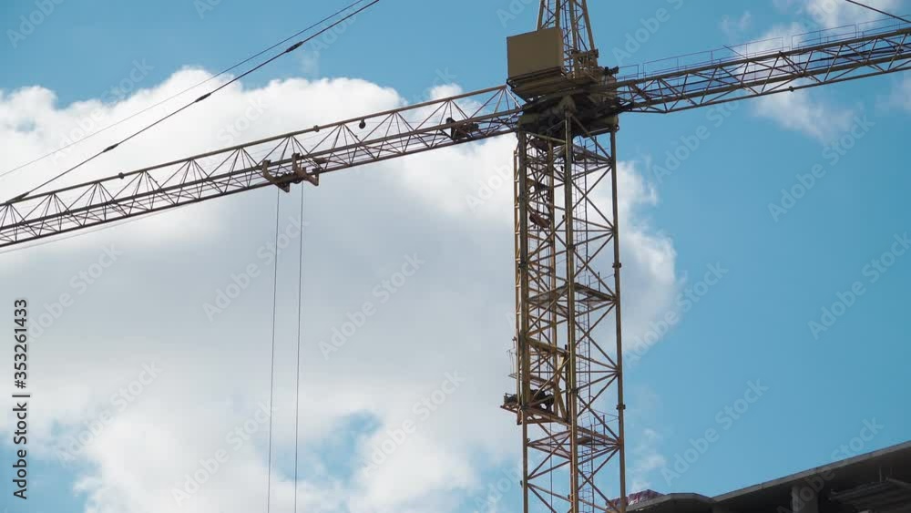 Big industrial construction crane with beautiful cloudy sky background. City development Big industrial construction crane with beautiful cloudy sky background. City development