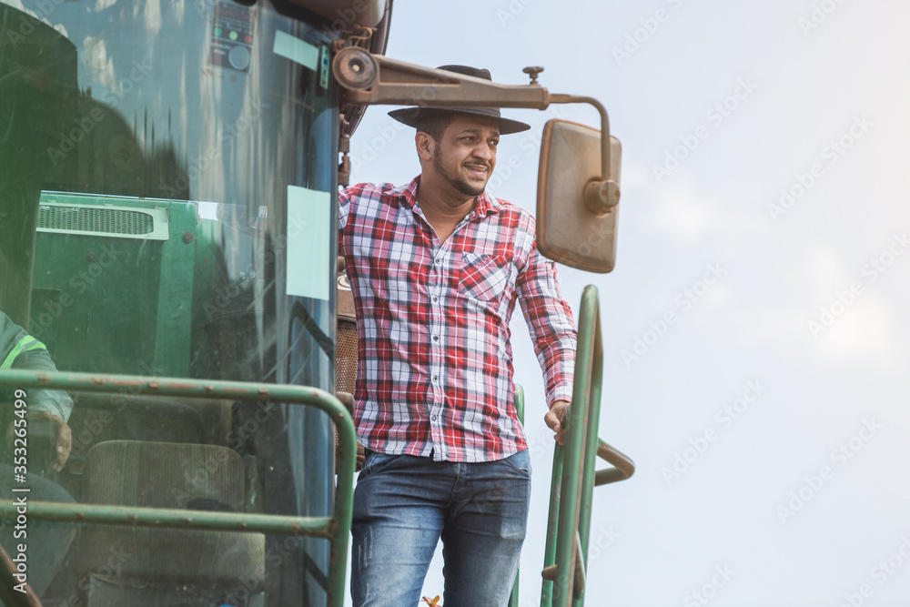 Rural businessman checking work. Sugarcane harvester machine. Farmer.
