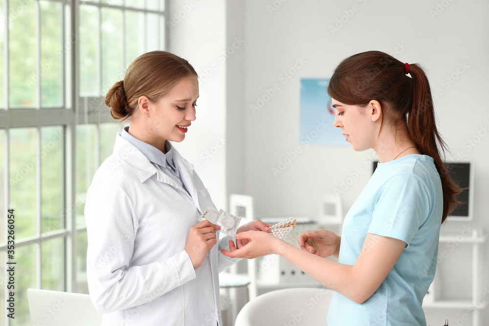 Female gynecologist and patient with different contraceptives in clinic Female gynecologist and patient with different contraceptives in clinic