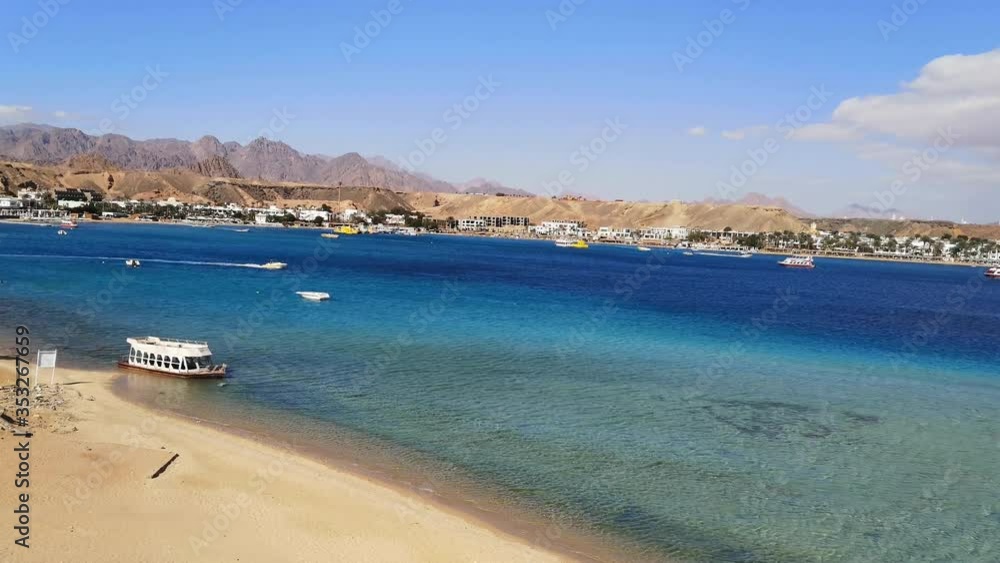 Desert-sea-mountain landscape of the Red Sea and Sharm El Sheikh on the opposite bank (Egypt) (14). Amazing seascape of an Egyptian resort with ships in blue water Desert-sea-mountain landscape of the Red Sea and Sharm El Sheikh on the opposite bank (Egypt) (14). Amazing seascape of an Egyptian resort with ships in blue water