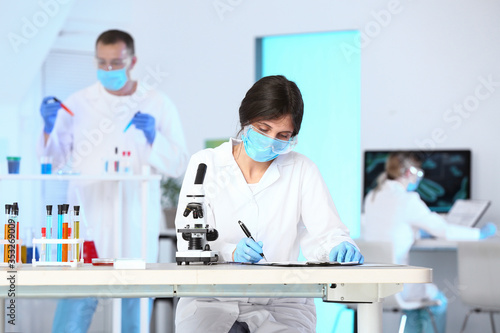 Scientist working with micr...