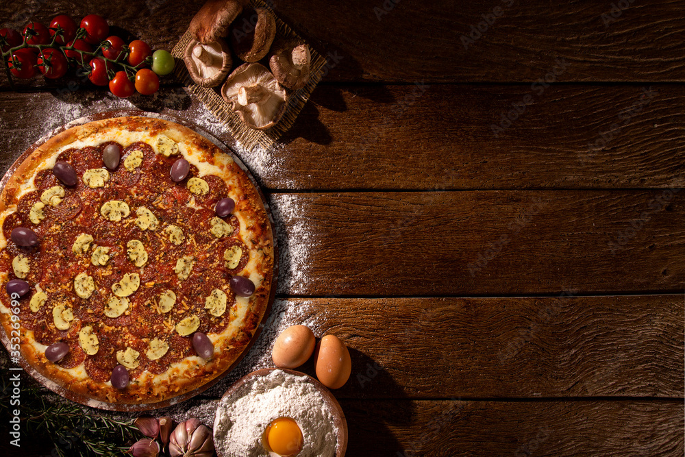 Brazilian pizza with tomato, cream cheese, olive and basil. Top view on black concrete background, close up. Traditional Brazilian Pizza Brazilian pizza with tomato, cream cheese, olive and basil. Top view on black concrete background, close up. Traditional Brazilian Pizza