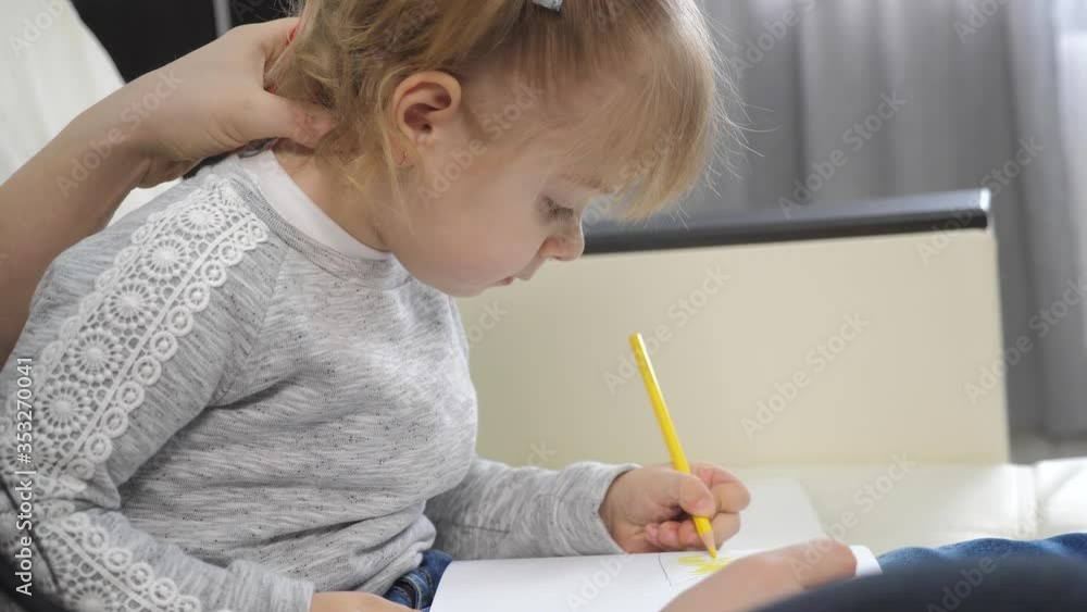 little girl and mom draw lifestyle teamwork happy family concept. child daughter with a woman are engaged in pencil drawing lesson with children development of creativity little girl and mom draw lifestyle teamwork happy family concept. child daughter with a woman are engaged in pencil drawing lesson with children development of creativity