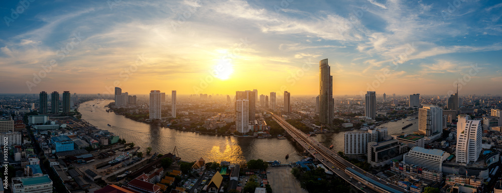 Panorama of Bangkok business district skyline and office skyscraper with Chao Phraya River during sunset in Bangkok, Thailand. Panorama of Bangkok business district skyline and office skyscraper with Chao Phraya River during sunset in Bangkok, Thailand.