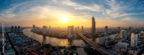 Panorama of Bangkok business district skyline and office skyscraper with Chao Phraya River during sunset in Bangkok, Thailand. 