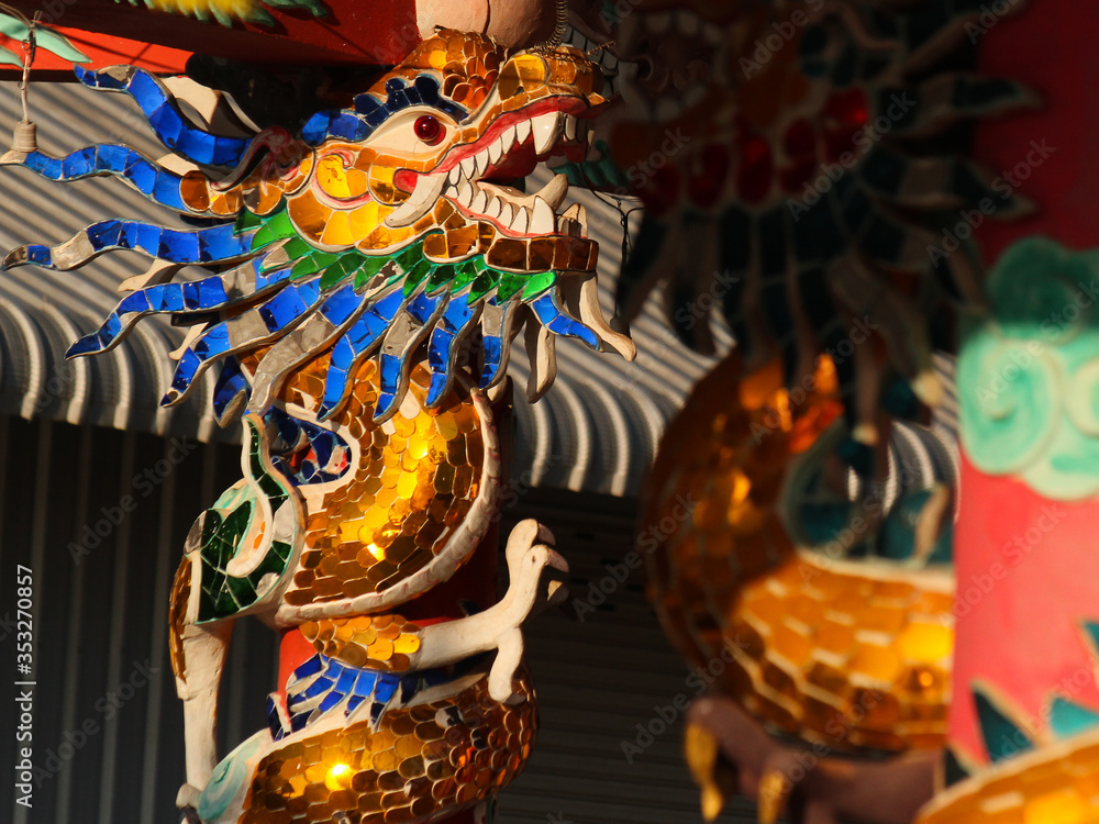 colorful glass mosaic dragon image as pillar decoration in a chinese temple in the city of savannakhet lao PDR