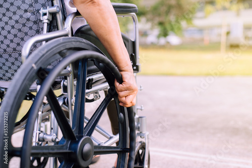 Disabled woman sitting on wheelchair at outdoor,Recovery and healthcare concept
