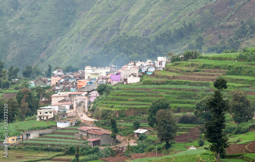A tiny village with multicolored houses in the mountains of Kodaikanal in India