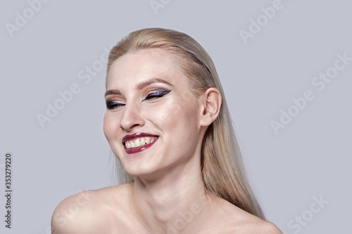 Happy blonde girl  beautiful white smile  bright makeup.