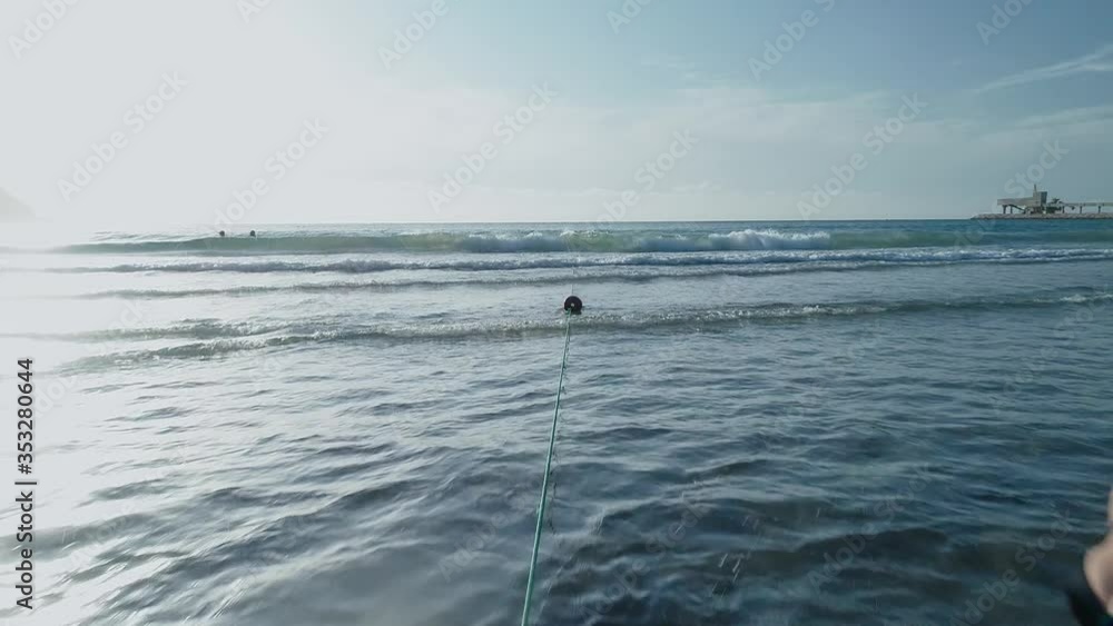 Two Caucasian women splash long hair standing face to face in shallow ocean water, low aerial slow motion Two Caucasian women splash long hair standing face to face in shallow ocean water, low aerial slow motion