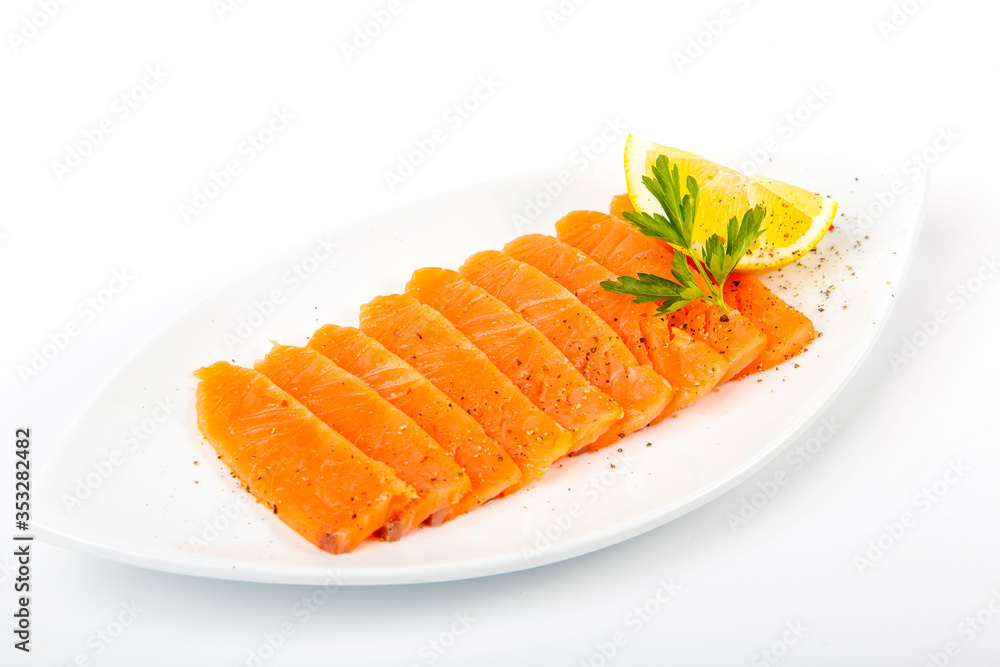 Salted salmon with butter and lemon. Plate on a white background Salted salmon with butter and lemon. Plate on a white background