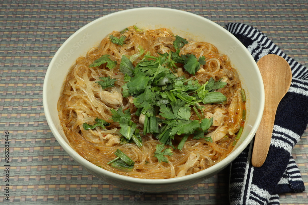 Traditional spicy glass noodle (Korea instant konjac noodle) with cutting fresh chicken thigh, chilly, lime juice, coconut milk and coriander. Famous hot and spicy menu in Thailand.