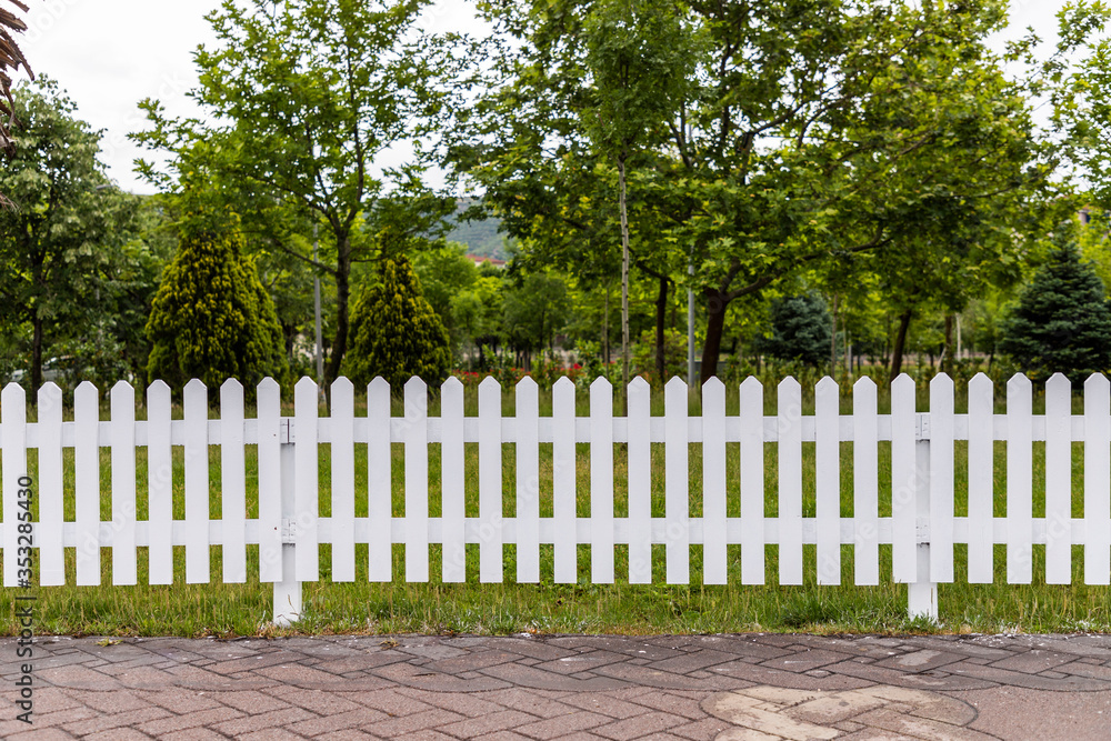 Wooden white fences around the garden Wooden white fences around the garden