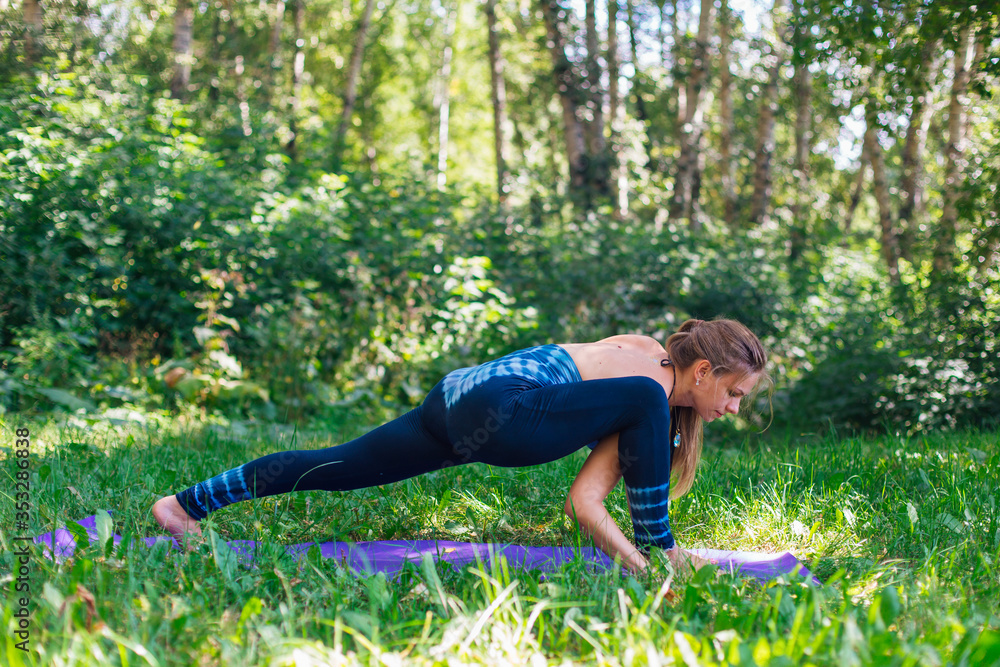 Young woman doing yoga exercises in summer city park. Young woman doing yoga exercises in summer city park.