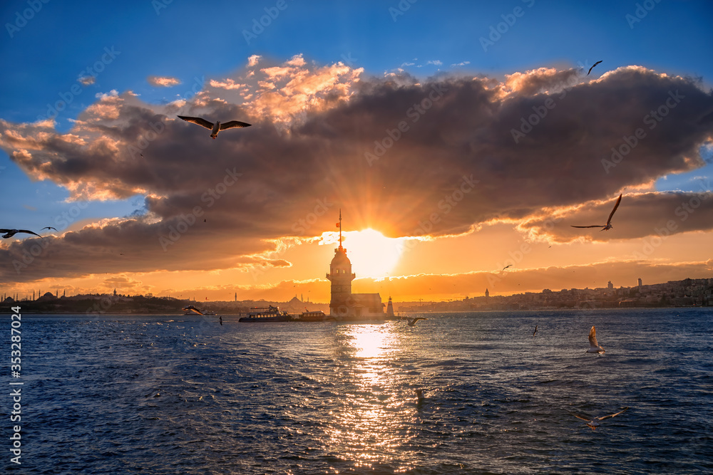 Fiery sunset over Bosphorus with famous Maiden's Tower (Kiz Kulesi) also known as Leander's Tower, symbol of Istanbul, Turkey. Scenic travel background for wallpaper or guide book 