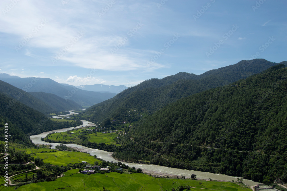 Long Beautiful Winding River in Bhutan Surrounded by Rolling Green Hills