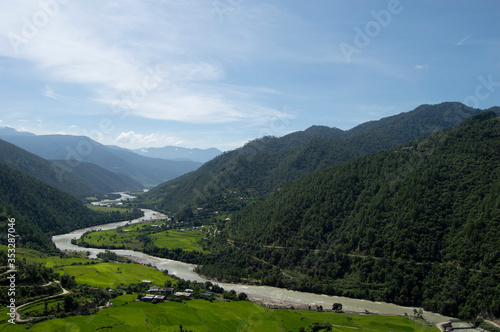 Long Beautiful Winding River in Bhutan Surrounded by Rolling Green Hills