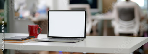 Wallpaper Mural Cropped shot of simple office desk with blank screen laptop, mug, notebooks and copy space Torontodigital.ca